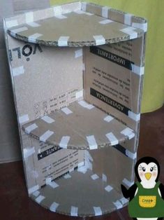 an open cardboard box with a penguin on it's chest and the bottom section is cut out