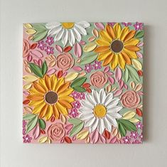 a painting with flowers painted on it is hanging on the wall in front of a white wall