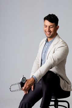 a man sitting on top of a stool