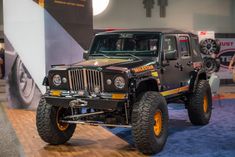 a jeep on display at an auto show