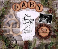 a baby announcement with deer antlers, pine cones and other items