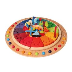 a wooden toy with lots of different colored shapes and colors on the top of it