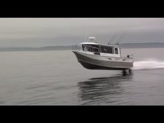 a boat is speeding across the water on a cloudy day with no one in it