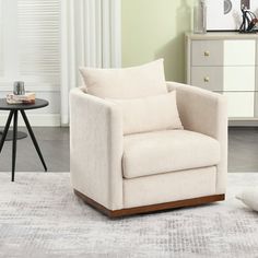 a white chair sitting on top of a rug in a living room