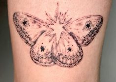 a small butterfly tattoo on the leg