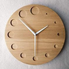 a clock made out of wood with holes in it