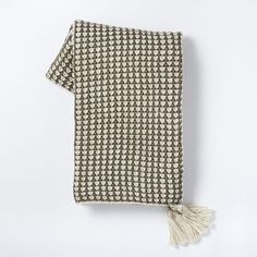 a black and white patterned scarf with tassels