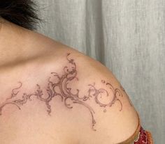 a woman with a tattoo on her shoulder