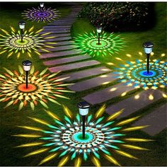 an array of colorful lights in the grass