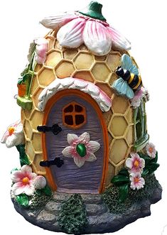 a figurine of a beehive with flowers on it