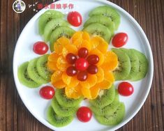 a white plate topped with sliced kiwis and tomatoes on top of each other