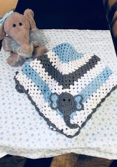 a crocheted blanket with a teddy bear on it and an afghan in the shape of a heart