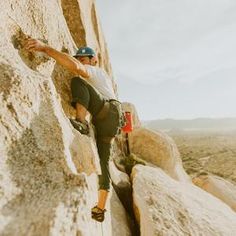 a man climbing up the side of a mountain