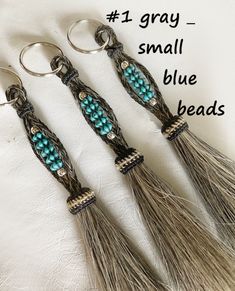 three tassels with beads on them are sitting next to the words, 1 gray - small blue beads