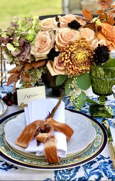 the table is set with flowers and napkins