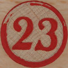 the number twenty two is painted on a piece of wood