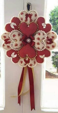 a red and white wreath hanging on the side of a door