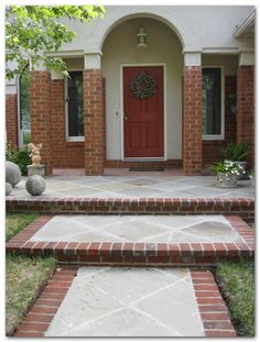 a brick house with steps leading up to the front door