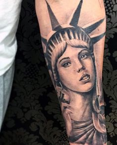 a lady liberty tattoo on the arm