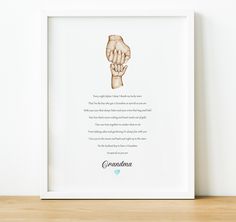 a framed print with a hand holding the word grandma