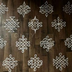 a wooden floor topped with lots of white designs