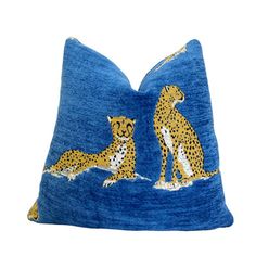 a blue pillow with two cheetah on it