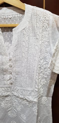 Elegant Cotton Top With Floral Embroidery, Elegant Cotton Tops With Floral Embroidery, Cotton Tops With Pintucks For Daywear, Elegant V-neck Tops With Chikankari Embroidery, Elegant Cotton Embroidered Top With Broderie Anglaise, Elegant Short Sleeve Top With Chikankari Embroidery, White Cotton Blouse With Tonal Embroidery, White Cotton Tops With Tonal Embroidery, Elegant Cotton Embroidered Top For Daywear