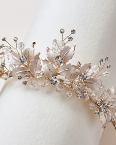 a bridal headpiece with flowers and leaves on it