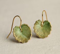 These olive green leaf earrings are brass charms with some amazing detail, which have been carefully treated, painted and varnished to bring out beautiful tones and depth of colour and to show the incredible veining and other details of the metal.  These are coloured a beautiful, delicate and multi toned olive green colour.   They are designed to be reminiscent of the beautiful, softly coloured lily pads found in Art Nouveau paintings. They are handmade in our Edinburgh studio and no two pairs a Handmade Enamel Jewelry, Lily Pad Earrings, Green Brass Earrings Nature-inspired, Olive Green Earrings, Accesories Outfit Jewelry, Green Wedding Accessories, Clay Earring Ideas, Art Nouveau Earrings, Lily Earrings