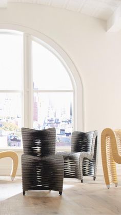 three chairs in front of a large window with an arch above them and the word love written on it