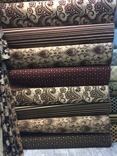 a pile of different colored and patterned fabrics