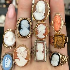 a person's hand with six different types of rings on it, including lady and man