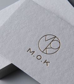 the monogrammed logo is on top of two folded paper