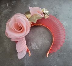 "Presenting a beautiful coral orange halo style  headpiece with peachy pink colour silk flower and gold leather leaf detail on a satin ribbon covered headband with hair comb slide. This stunning headpiece is adorned with a silk rose flower vine which extends above the headband and is wired so the flowers can be adjusted slightly to work with your hair style. Its also delightfully lightweight to wear. Shown above on one of our stunning clients who kindly shared up pictures. Perfect to add a uniqu Halo Fascinator, Coral Headpiece, Elegant Orange Summer Headpiece, Orange Headband Fascinator For Wedding, Flower-shaped Fascinator With Matching Headband For Party, Orange Fascinators, Luxury Flower-shaped Fascinator For Wedding, Luxury Flower-shaped Wedding Fascinator