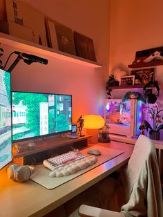 a computer desk with two monitors and a keyboard in front of the monitor is lit up