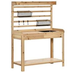 a wooden work bench with two baskets on the top and one shelf above it,