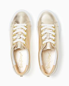 Leather lace up sneaker with gold metallic and pave rhinestone accents. Solid Nappa Leather. Imported. Step into the sunshine with our Hallie Sneakers, a goes-with-everything pair    made from white leather with gold metallic details and rhinestone accents. Gold Lace-up Sneakers With Metallic Logo, Gold Low-top Sneakers With Metallic Logo, Casual Gold Lace-up Sneakers, Gold Low-top Platform Sneakers, Gold High-top Sneakers With Perforated Toe Box, Gold Low-top Casual Sneakers, Gold Leather Sneakers With Laces, Sporty Gold Platform Sneakers With Round Toe, Gold Low-top Sneakers With Laces