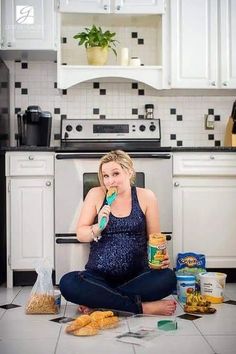 a woman sitting on the floor eating food