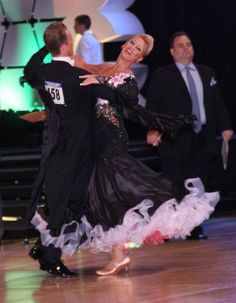 a man and woman dancing on a dance floor