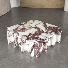 a marble table sitting on top of a cement floor