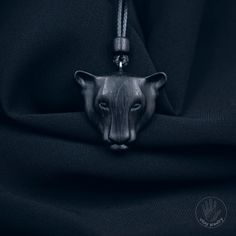 a black cat head hanging from the side of a black cloth