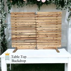 a table top with wooden slats on it and some balloons hanging from the ceiling