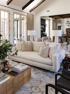 a living room filled with furniture and lots of windows