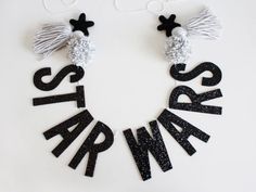 black and white letters with tassels on them