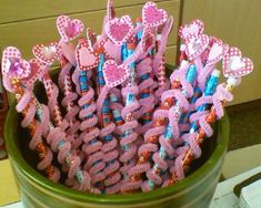 there are many toothbrushes in the cup on the table and one is decorated with hearts