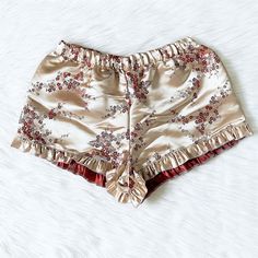 LISTING IS FOR ONLY ONE PAIR OF SHORTS Gorgeous, silky soft satin floral embroidery adult pajama shorts that are perfect all year round! A perfect pair to wear while lounging around the house. Great for birthday gifts, Christmas gifts, Valentine's Day, or even Bridal parties! Comes with a stretchy elastic waistband for a comfort. Cute ruffle trim finishes off the shorts. 100% Satin Plaid PJ Shorts here: https://www.etsy.com/listing/1060519934/red-black-white-adult-women-pajama?ref=listings_manag Ruffle Trim Shorts, 4th Of July Dresses, Short Satin, Red Pajamas, Pyjama Satin, Party Photoshoot, Women Sleepwear, Adult Pajamas, Pj Shorts