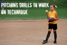 a woman in yellow shirt and black shorts holding a baseball glove on top of a field