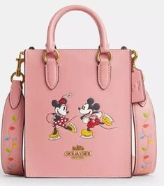 **COACH X DISNEY ... NORTH/SOUTH TOTE** **FEATURING:  MINNIE & MICKEY MOUSE MOTIF** **FABULOUS BLUSH PINK COLOR** **YEAR-ROUND USE** **ALWAYS THE LOWEST PRICE ON THE INTERNET** Details: *Brand new with original price tags attached... *Retail price:  $398.00 + tax... *Style #CN023... *Color:  Light Blush, Multi... *Material:  refined calf leather... *Interior:  2 credit card slots... *Magnetic snap closure... *Fabric lining... *Top Handles with:  2 1/4" drop... *Removable crossbody strap with 23 1/4" drop for shoulder or crossbody wear...  2 in 1 ... Tote & CrossBody... *Measurements: 5.5"L x 6 3/4"H x 2"W... *Leather:  Coach x Disney hangtag... *Interior:  leather authenticity patch... *Free shipping... *Arrives at your home wrapped in Coach paper; gift boxes are available  ... message us. Disney Carry On, Pink Coach Bag, Funky Purses, Disney Backpack, Coach Disney, Disney Purse, Disney Bags, Summer Boots, Disney Handbags