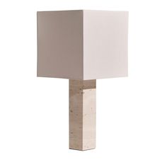 a lamp that is sitting on top of a white table cloth with a square shade