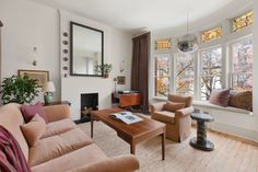 a living room with two couches and a coffee table in front of a window